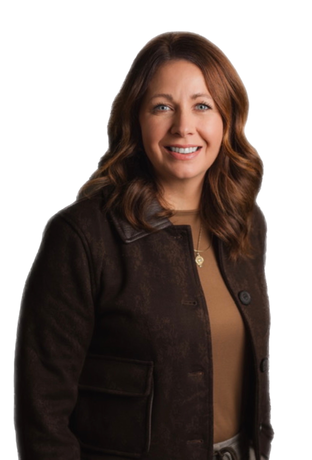 A smiling woman with long brown hair and blue eyes wears a textured brown jacket over a tan top with a gold pendant, all against a white background.