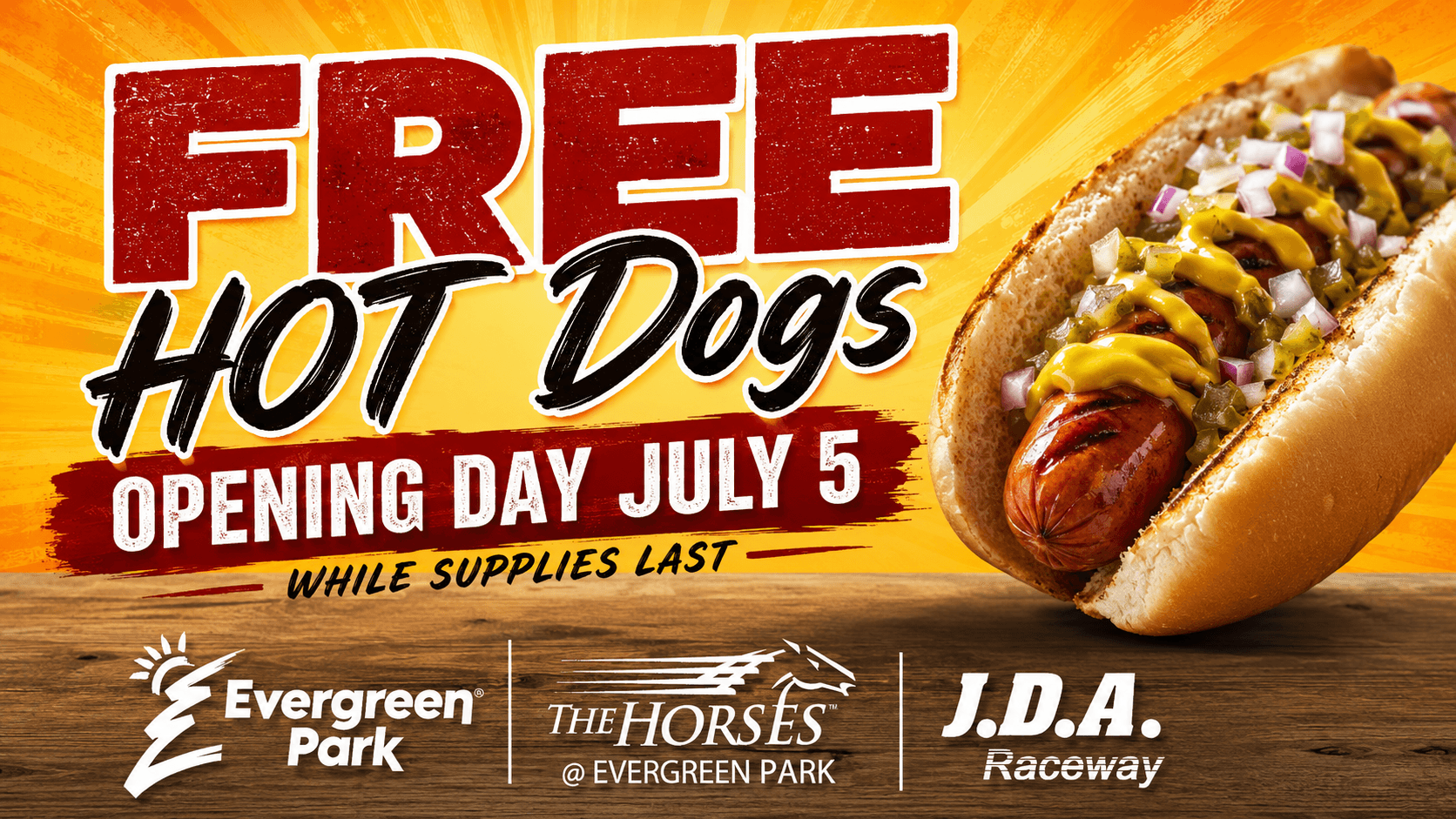 An advertisement on a vibrant yellow and orange radial background displays a grilled hot dog topped with mustard, relish, and diced red onions, with large text promoting free hot dogs on opening day July 5 while supplies last, and logos for Evergreen Park, The Horses, and J.D.A. Raceway visible on a wooden surface below.